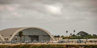 Military Plane Crashes, All 32 Aboard Killed airport hangar with helicopters near a shoreline