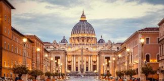 Vatican Confirms Abuse Findings Against Priest St. Peter's Basilica at the end of a wet street at dusk