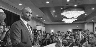 Byron Donalds Sparks Profanity-Filled Uproar Colin Allred speaks at a podium as Christian Jones and a crowd applaud