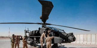 Saudi Under Fire – Egypt Eyes Deployment Soldiers inspect a military attack helicopter on a tarmac