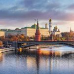 Preemptive Strikes: NATO Hubs in Crosshairs Kremlin complex by a river at sunset