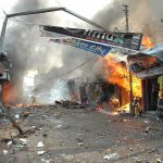 Street marketplace engulfed in fire and heavy smoke