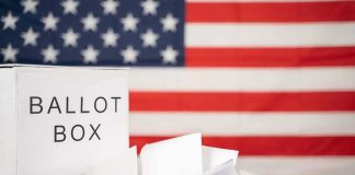498 Ballot Envelopes Vanish – Found States Away Ballot box with papers in front of an American flag