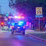 Gunfire At Game – Bonded Out Fast Emergency vehicles with flashing lights on a city street at night