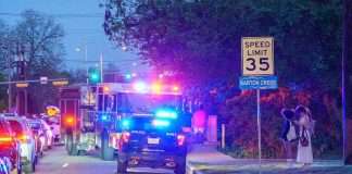 Gunfire At Game – Bonded Out Fast Emergency vehicles with flashing lights on a city street at night