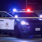 Overdose Money Buys Tahoes, Spy Cameras Police SUV with flashing lights at night behind yellow tape