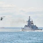 military ships and helicopter at sea