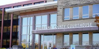 Wall Street Fraudster Owes $59 Million Waukesha County Courthouse entrance with glass facade and signage