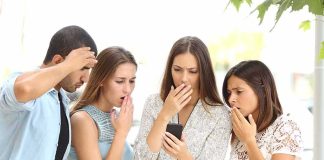Group of friends looking shocked at a smartphone