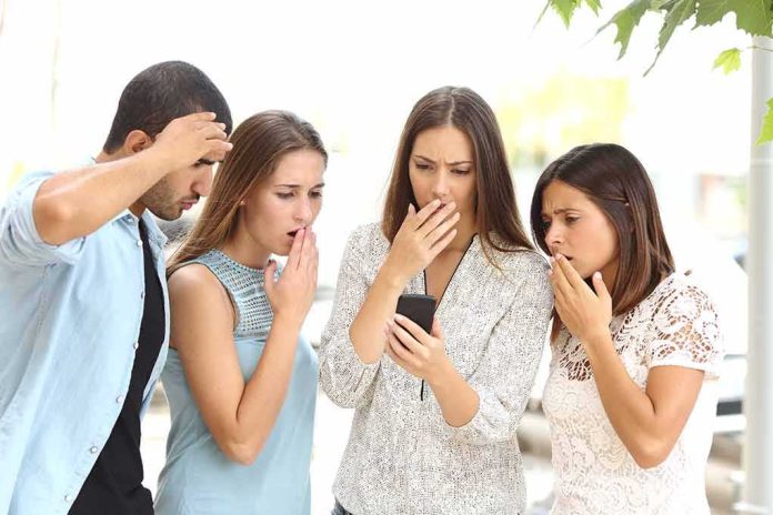 Group of friends looking shocked at a smartphone