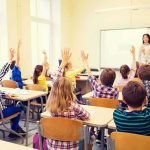 Drunk Teacher Meltdown Inside Classroom Students raise hands in a classroom with a teacher at the front