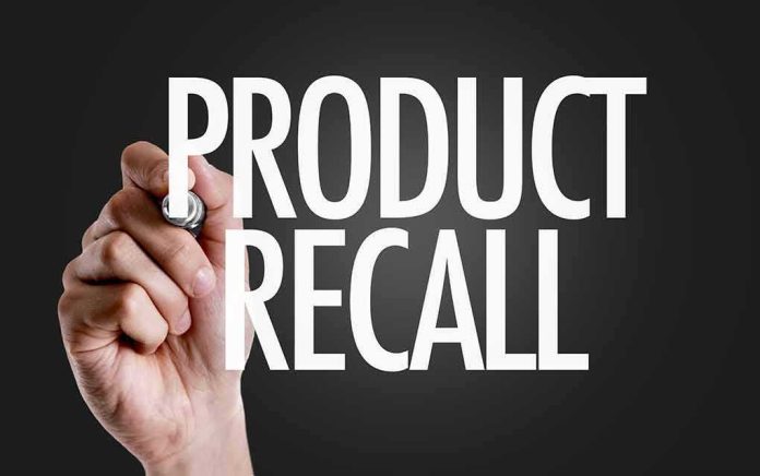 Hand writing product recall on dark background
