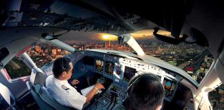 Mid-Air Attack Forces Emergency Diversion Pilots in an airplane cockpit during city approach at sunset