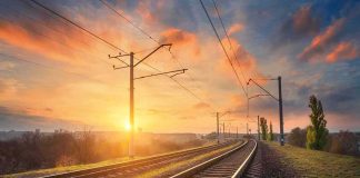 Rear‑End Slam Shuts Madrid – Seville Lifeline Curved railway tracks under power lines at sunrise