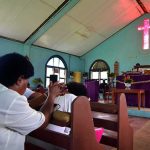 Teen Church Stunt Sparks Shock Closure Congregation inside a church with a speaker at the pulpit