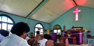 Congregation inside a church with a speaker at the pulpit
