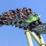 Six Flags Tragedy Sparks Urgent Probe roller coaster train with riders on a curved track