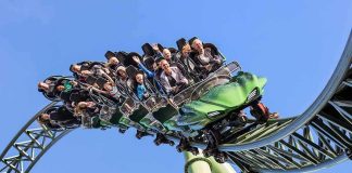 Six Flags Tragedy Sparks Urgent Probe roller coaster train with riders on a curved track