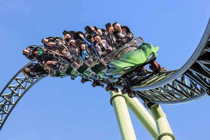 shutterstock_664913563 roller coaster train with riders on a curved track