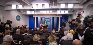 Threat Avalanche Hits Secret Service Press secretary at podium addressing reporters in briefing room