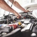 Mechanic working on a car engine bay