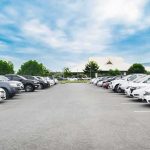 Tow Trap Empties Aftershock Parking Parking lot lined with cars under a blue sky